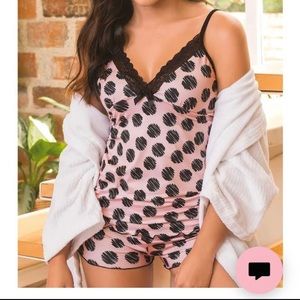 Beautiful short pajamas and pink strappy blouse with black circles.